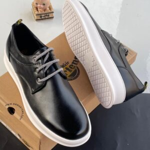 Dr. Martens black leather shoes with patterned laces and white sole