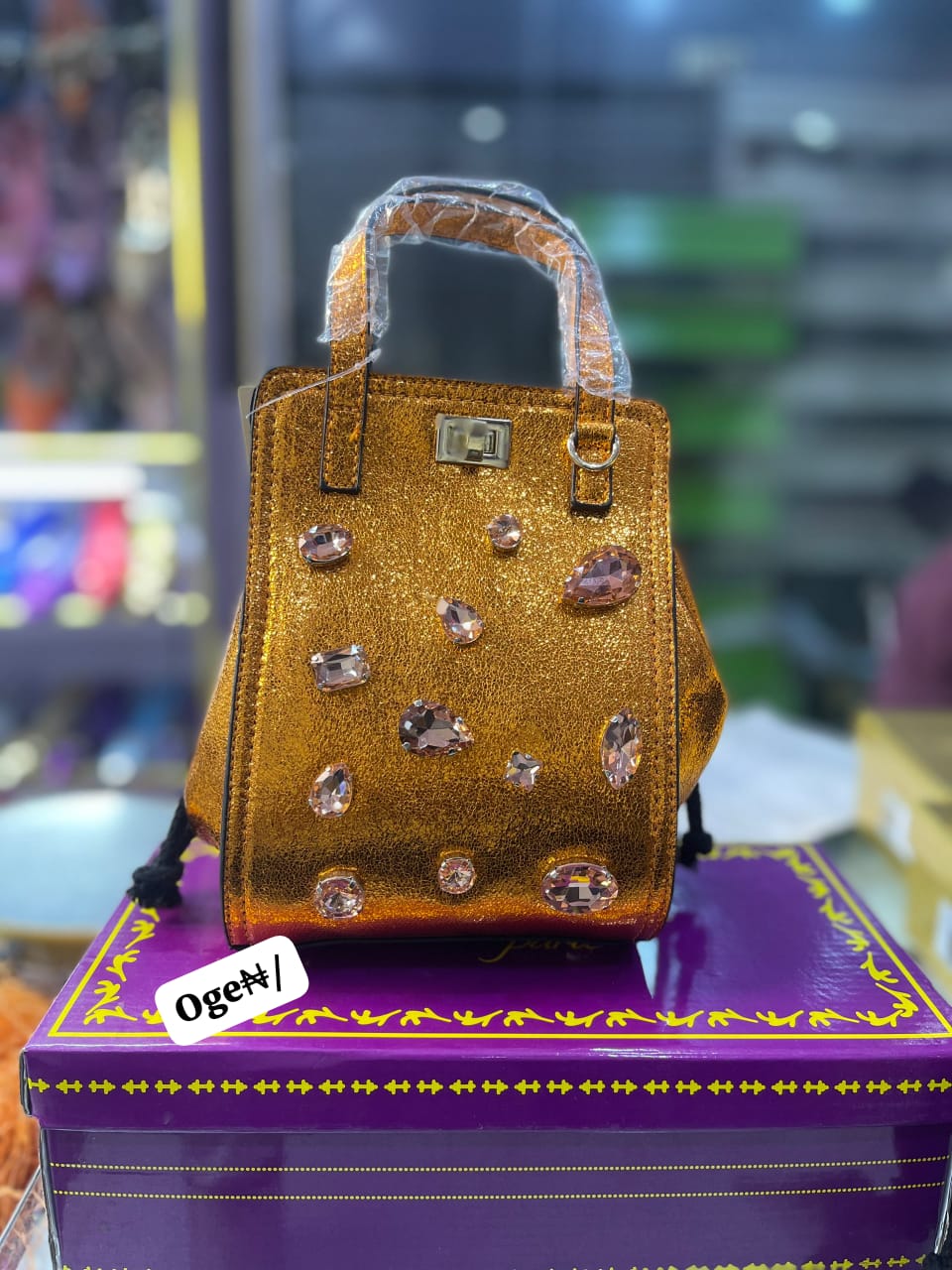 Elegant Textured Satchel with Jewel Accents and Top Handle